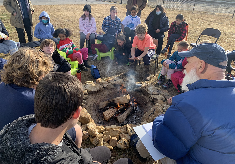 Image of children around a fire at Elkin, NC Valley Montessori language arts classes