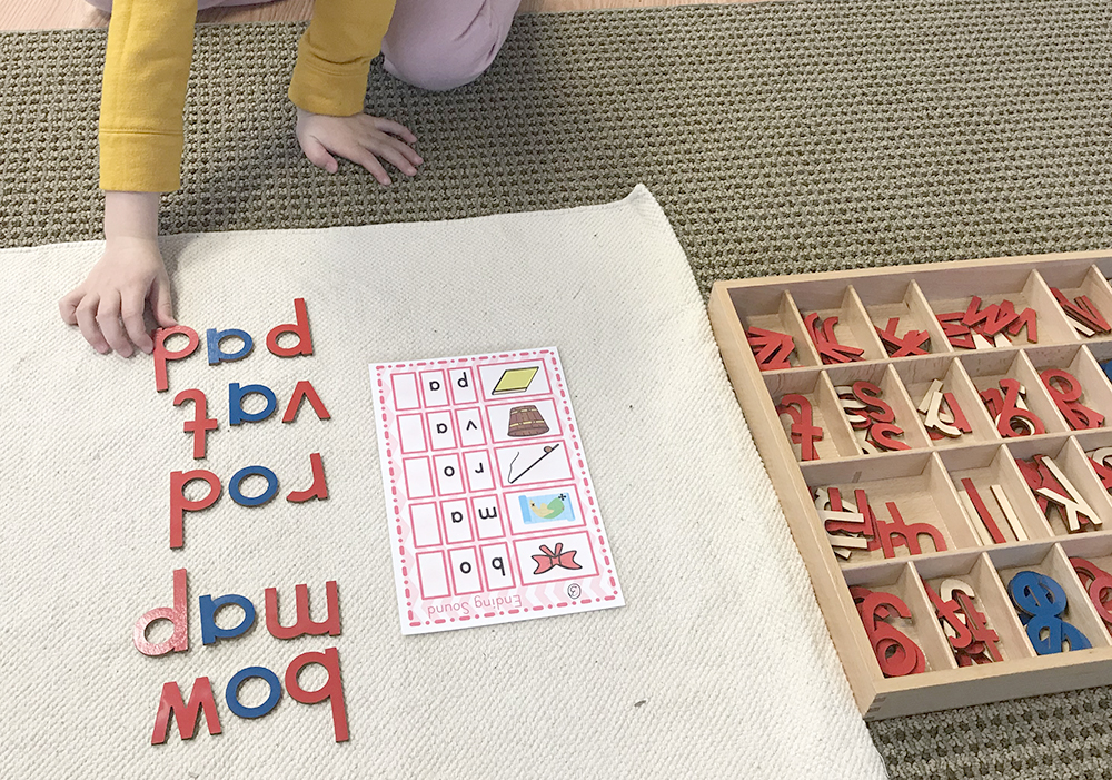 Image of child using teaching tools to form words with letters in Yadkin Valley montessori language arts classes