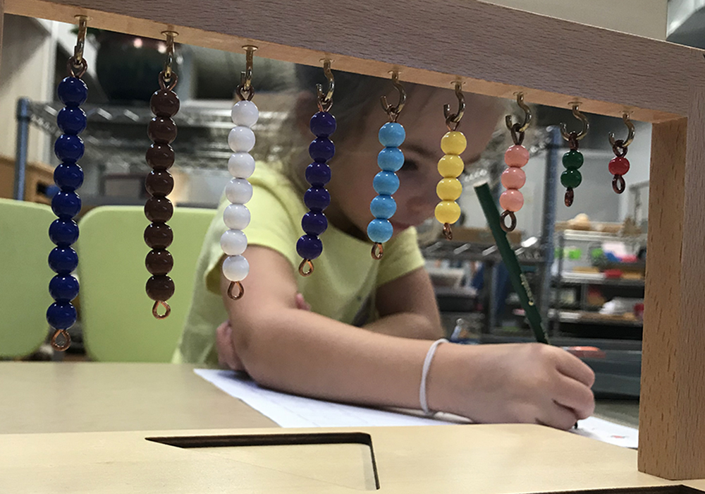 Image of child using Bead Stair in Yadkin Valley Montessori Math Classes